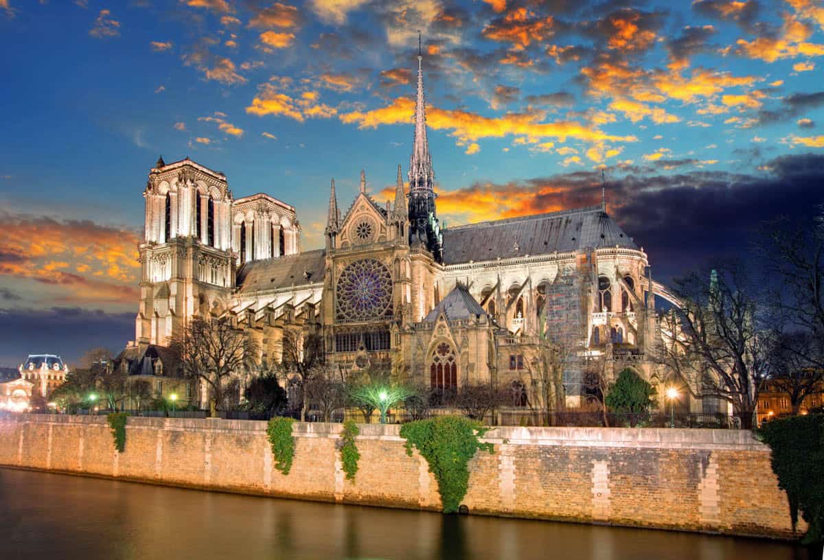 Notre-Dame Cathedral in Paris, France, with Notre-Dame apse and flying buttresses glowing above the Seine.